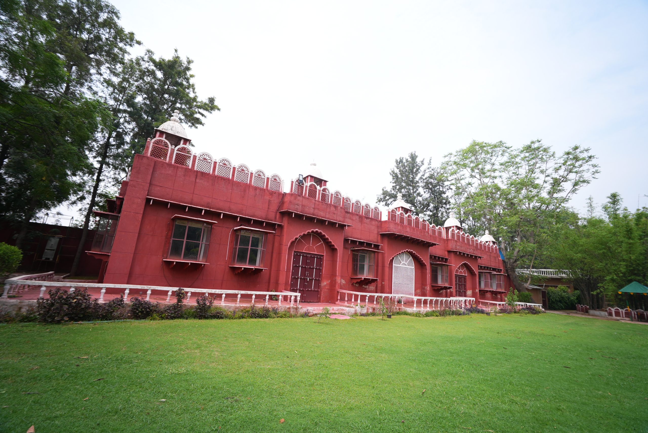 Traditional architecture surrounded by green lawn at Surjivan