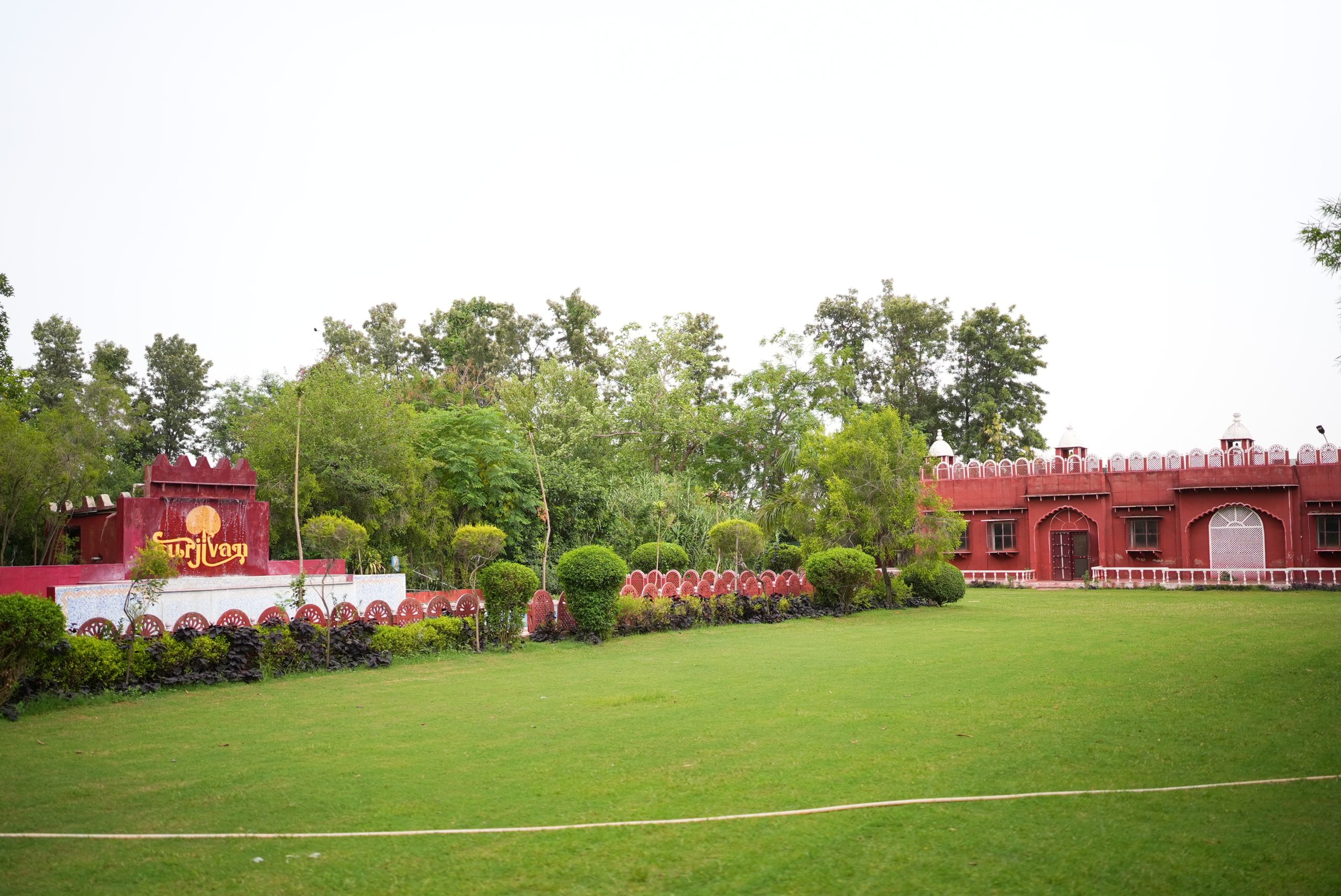 Green lawns and traditional architecture at Surjivan Resort